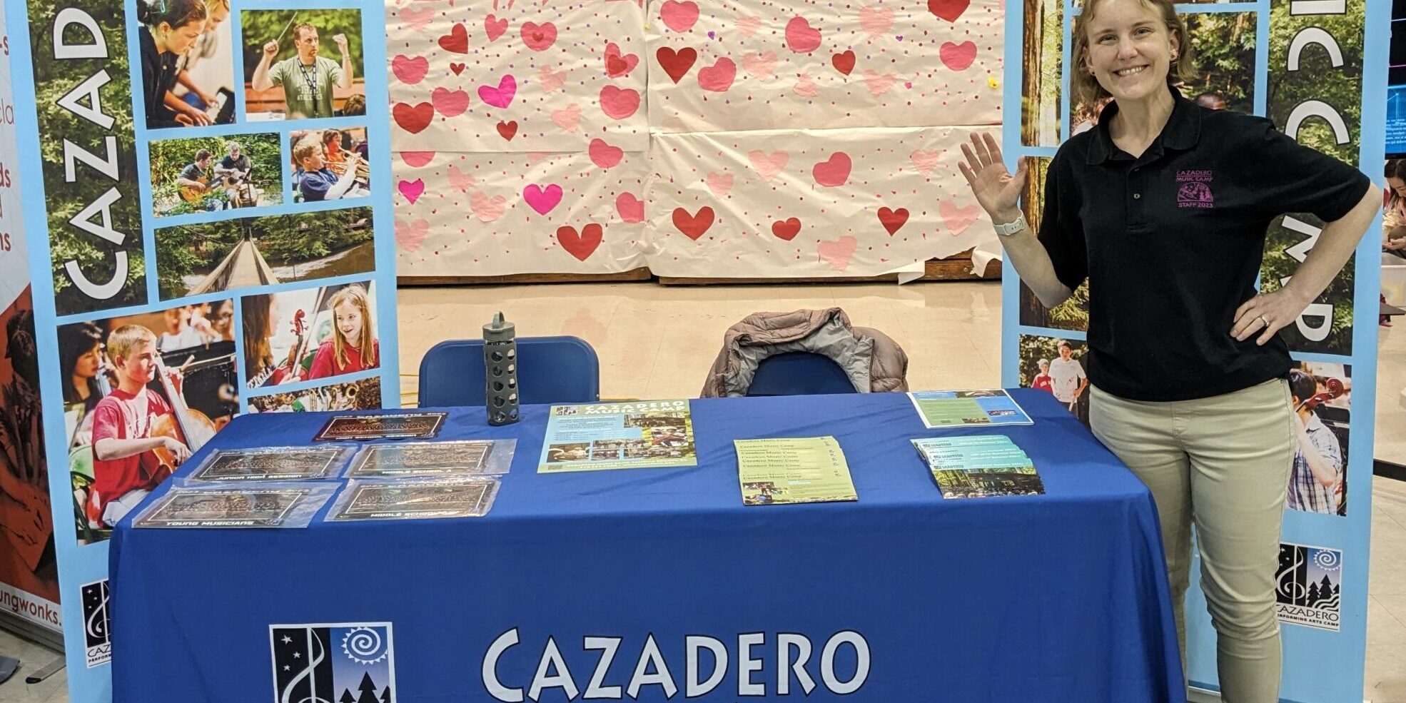 Staff smiling at a camp fair booth