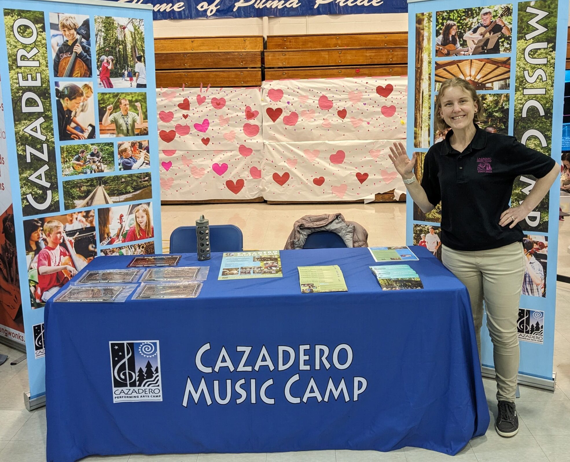 Staff smiling at a camp fair booth